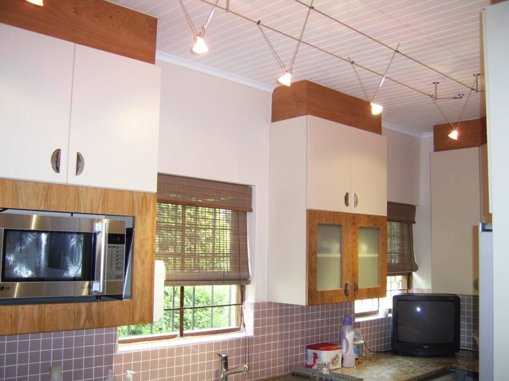 Custom kitchen upper cabinets with wood accents and integrated microwave